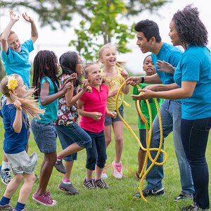 Kids in a day camp gather around their counselors.
