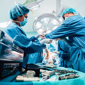 Surgeons operating on a patient.