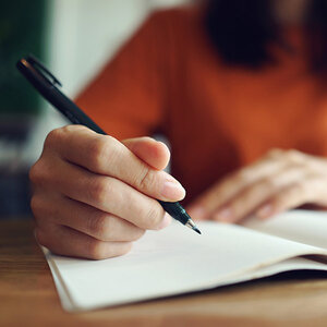 A writer working in a notebook.