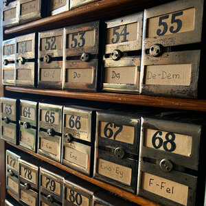 An image of an old archive with numbered metal boxes.