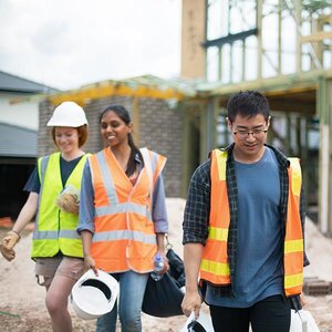 A group of young people working at a construction site.