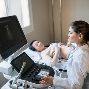 A woman getting an ultrasound done. A woman getting an ultrasound done.