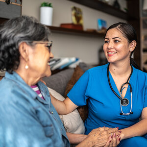 A nurse talking to an elderly woman. A nurse talking to an elderly woman.