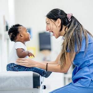 A nurse playing with a child. A nurse playing with a child.