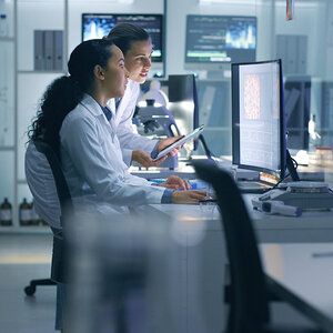 Two medical professionals reading. Two medical professionals reading.