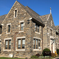 The fieldstone façade of a school building with a cross at its peak—Waldron Mercy Academy. The fieldstone façade of a school building with a cross at its peak—Waldron Mercy Academy.