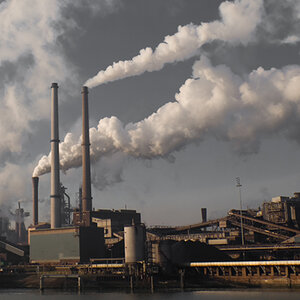 A coal-fired power plant spews smoke into the sky. A coal-fired power plant spews smoke into the sky.