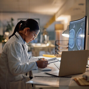 A researcher looking over her notes. A researcher looking over her notes.