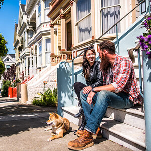 A couple sits on their stoop in San Francisco. A couple sits on their stoop in San Francisco.