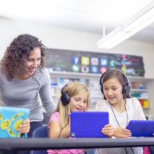 Children in school working on a tablet. Children in school working on a tablet.