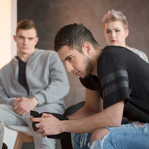 A college student participates in a group therapy session. A college student participates in a group therapy session.