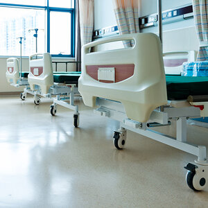 A three empty hospital beds.