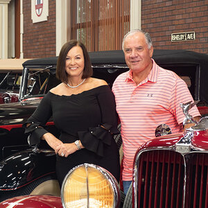 Philanthropists Johnny (right) and Terry Gray stand amid a collection of classic cars. Philanthropists Johnny (right) and Terry Gray stand amid a collection of classic cars.