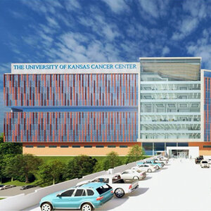 An artist’s rendering of a modern medical building surrounded by trees with a parking lot in the foreground
