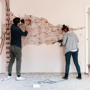 A couple repairing their home.