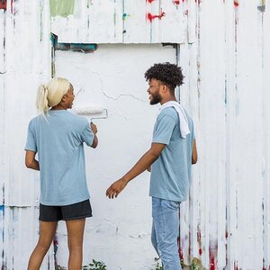 Volunteers repainting a building.