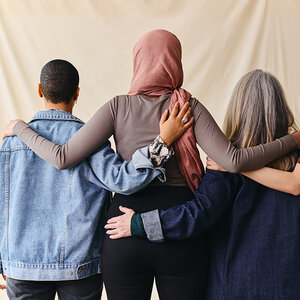 Women linking arms in support.