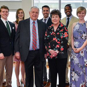 An older couple poses for a photo with scholarship winners – a photo including Leon and Sandra Levine.