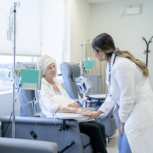 A woman receiving chemotherapy treatment.