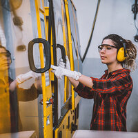 A young woman working in a factory. A young woman working in a factory.