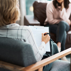 A therapist sitting with a client.