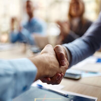 Two people shaking hands. Two people shaking hands.