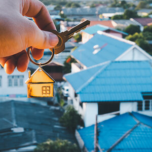 House keys with a suburban neighborhood in the background. House keys with a suburban neighborhood in the background.