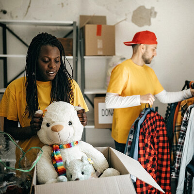 Two volunteers packing donation boxes.