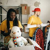 Two volunteers packing donation boxes.