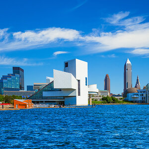 A city skyline at the edge of a lake with deep blue skies – Cleveland, Ohio.