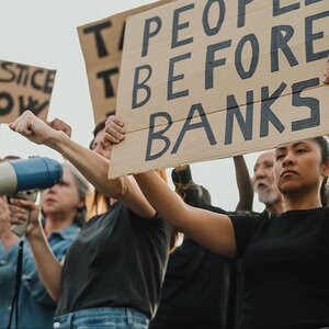 Protesters holding signs. Protesters holding signs.