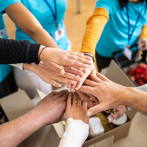A group of people with their hands piled together.