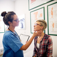 A doctor giving a patient a check-up. A doctor giving a patient a check-up.