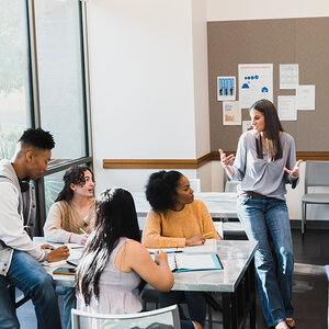 A teacher in a classroom full of young adults. A teacher in a classroom full of young adults.