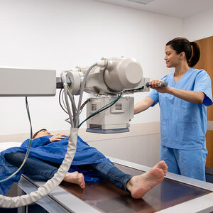 A radiologist taking an x-ray of a patient's ankle. A radiologist taking an x-ray of a patient's ankle.