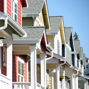A row of colorful homes suggesting homeownership in a vibrant neighborhood. A row of colorful homes suggesting homeownership in a vibrant neighborhood.