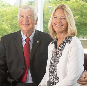 George and Kathy Bishop, smiling in front of a window. (Photo by Beth Wynn)