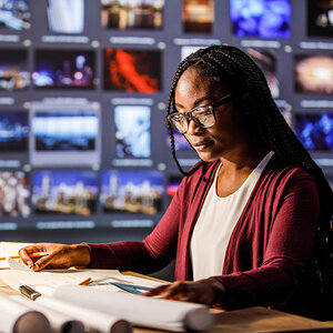 A journalist in a newsroom. A journalist in a newsroom.