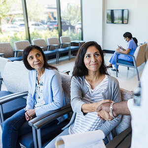 Women in a hospital meeting a doctor.