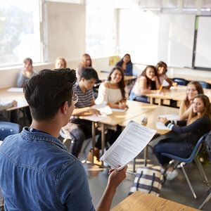 A speaker addressing a classroom full of students. A speaker addressing a classroom full of students.