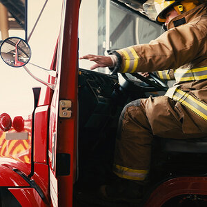 A Navajo firefighter closes the door of the firetruck he's about to drive. A Navajo firefighter closes the door of the firetruck he's about to drive.