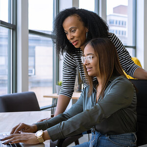 A female mentor provides on-the-job training for a young woman. A female mentor provides on-the-job training for a young woman.
