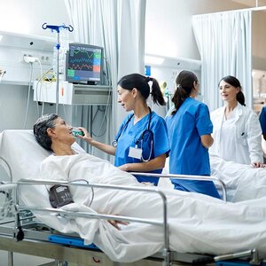 A nurse talking with a patient in a hospital.