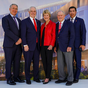 Four men in blue suits and a woman in a red jacket pose for a group photo - an image including Kenneth Griffin, Jack Nicklaus, and Barbara Nicklaus.