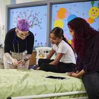 A doctor talking to a child in a hospital. A doctor talking to a child in a hospital.