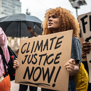 protester carries a sign calling for climate justice