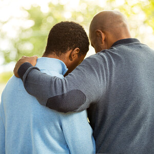 A mentor and is mentee lock arms.