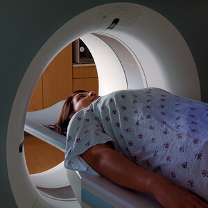 A woman is being examined using a CT scan machine. A woman is being examined using a CT scan machine.