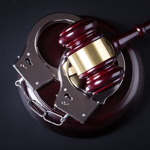 A judge's gavel and handcuffs. A judge's gavel and handcuffs.