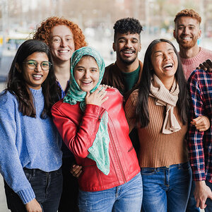 A diverse group of young men and women smiling at the camera. A diverse group of young men and women smiling at the camera.